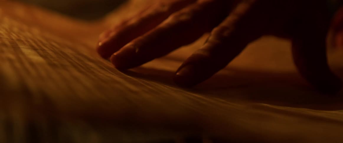 A person running their hand over cloth