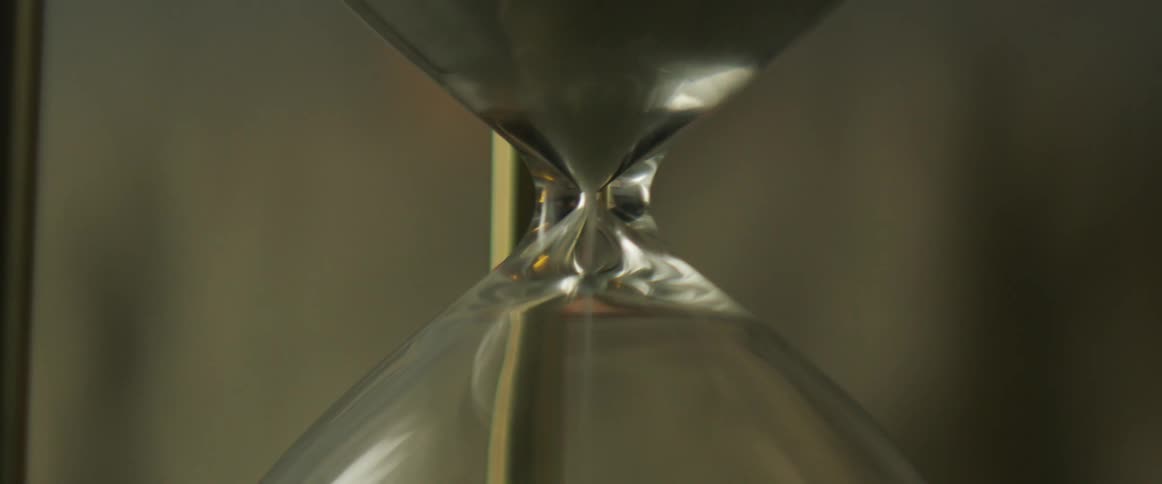 Sand runs through an hour glass