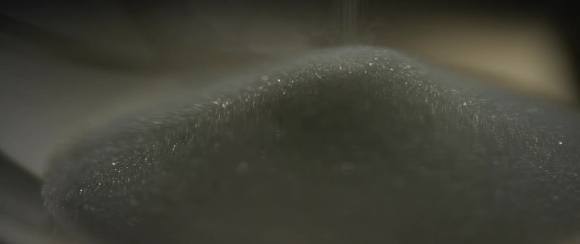 Close up of salt pouring on a salt mound