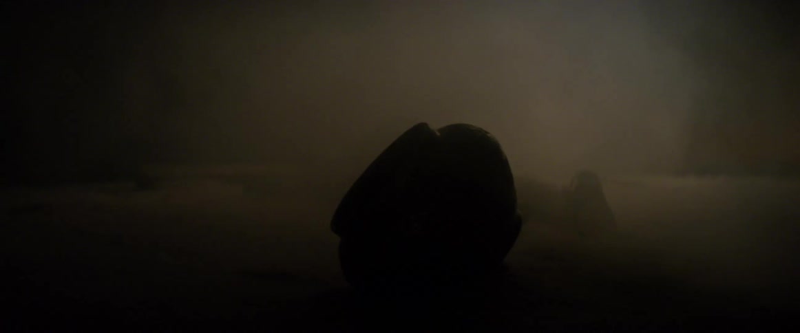 Pottery lying in the sand as dust blows over it