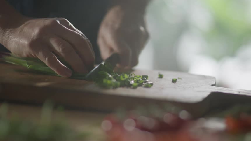 A man chopping onions