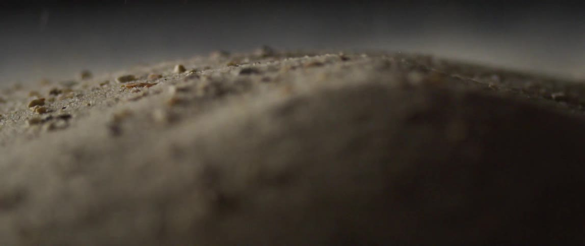 Particles fall onto shaking pile as others roll around