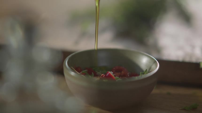Oil is poured onto a salad