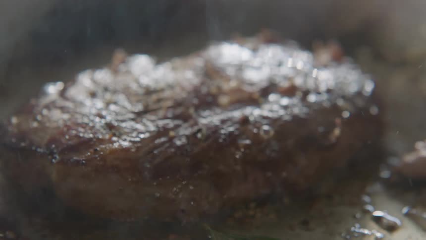 A filet sizzles and smokes as it cooks