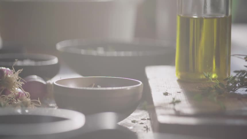 Spices are dropping into the bowl on the table