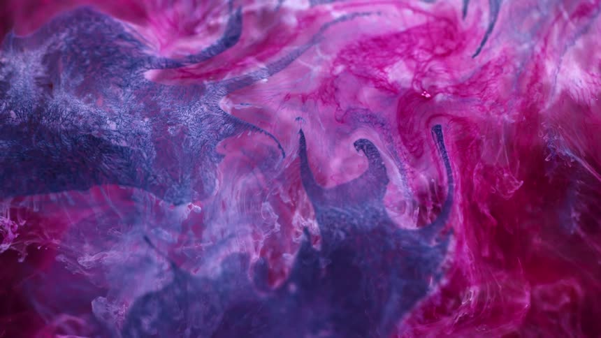 Pink and white paint are painted on a black wall in a random swirl pattern
