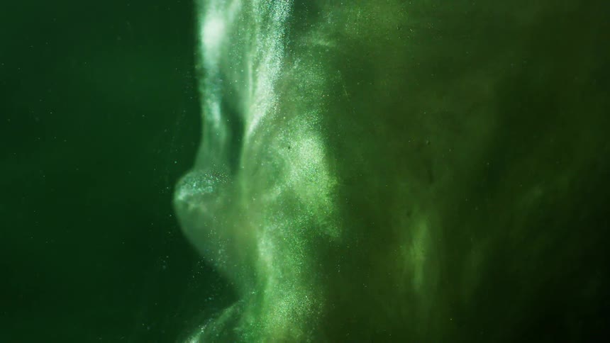 A green liquid is flowing downward