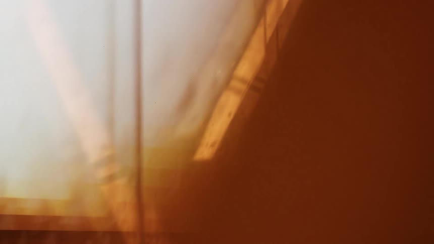 Bright light shines various colors on a wall