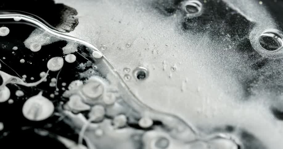 A person drops some liquid into paint