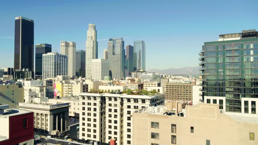 Roof top greenery occupies building near downtown as city stretches to mountains on the horizon