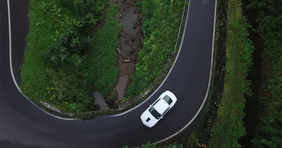 The cars drive around the turning road