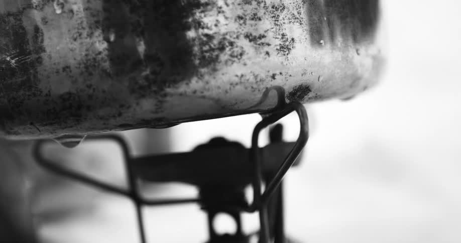 A pot sitting on a burner outside