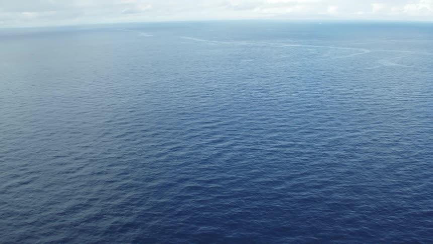 Calm blue ocean water under a blue sky