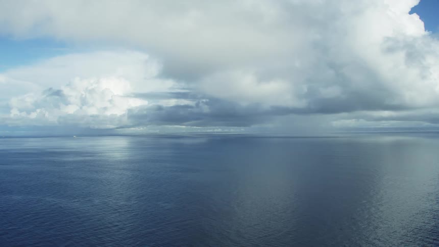The heavy clouds float above the ocean