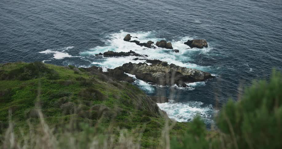 Waves lap some rocks near the coast