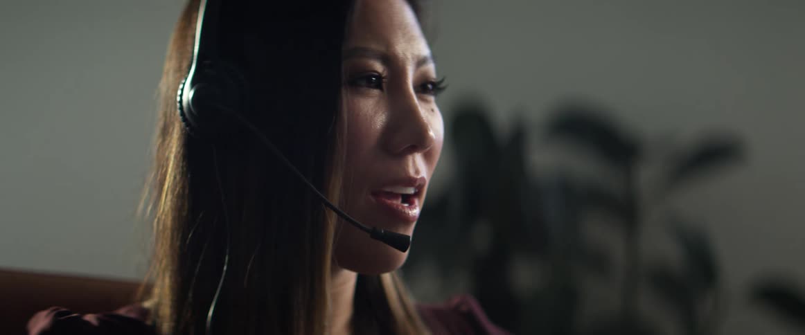 Woman speaking through a headset in the office