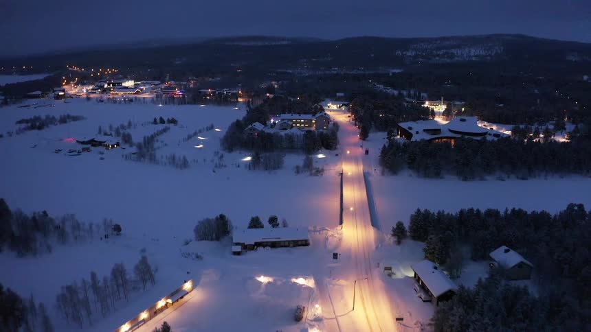 Aerial view of a small town covered in snow in the evening at winter