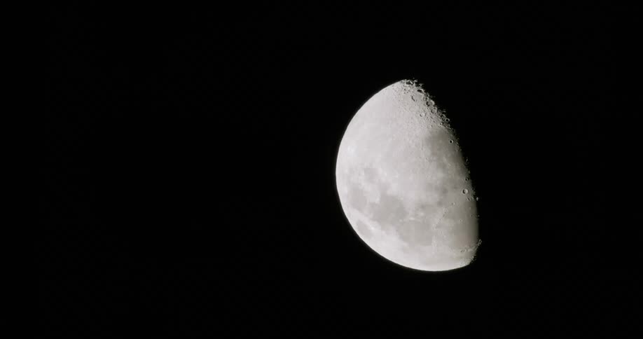 The moon is half in darkness