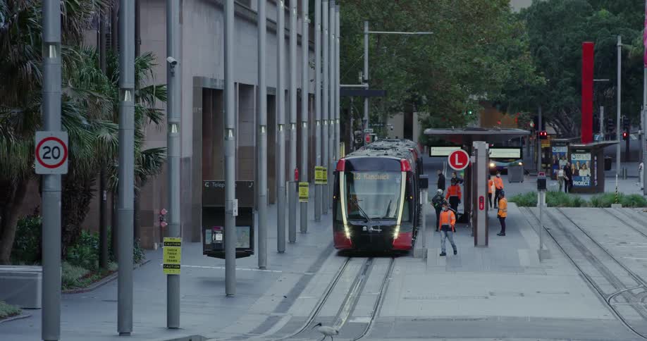 Several people are walking near a stopped train