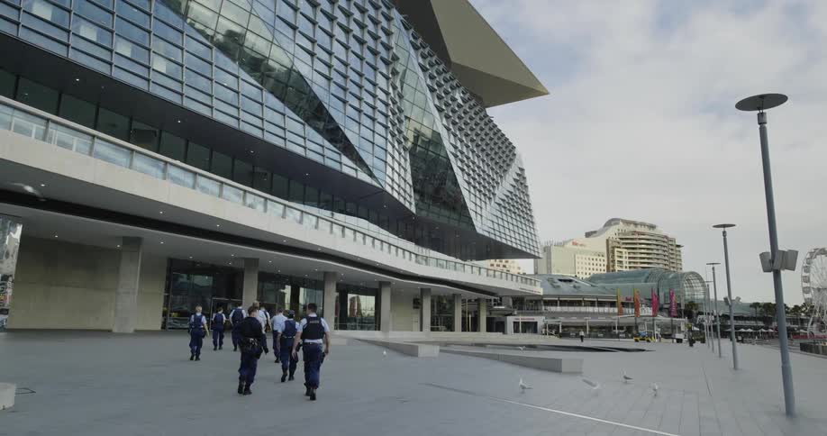 People walking towards a large building