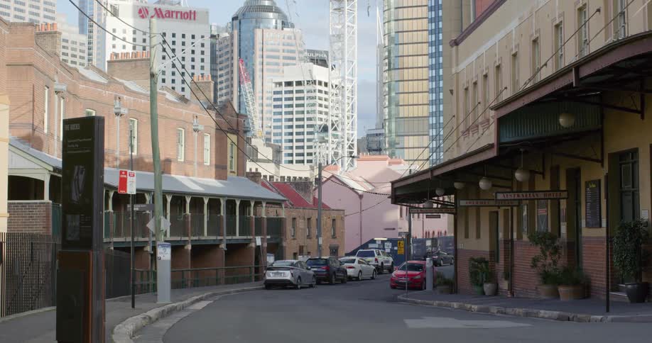 Cars parked on a street in a city near skyscrapers