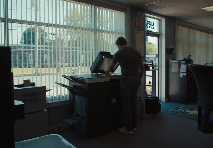 A man is making copies in the office