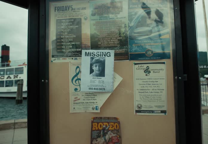 A man puts a missing sign on a sign post