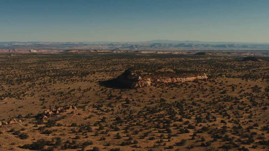 A mesa in a vast badland during the day