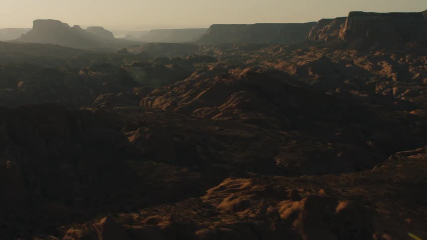 The sun illuminates a rocky terrain