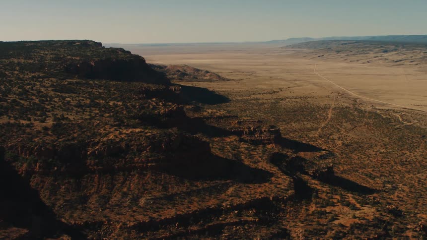 The canyon is lined by a long field