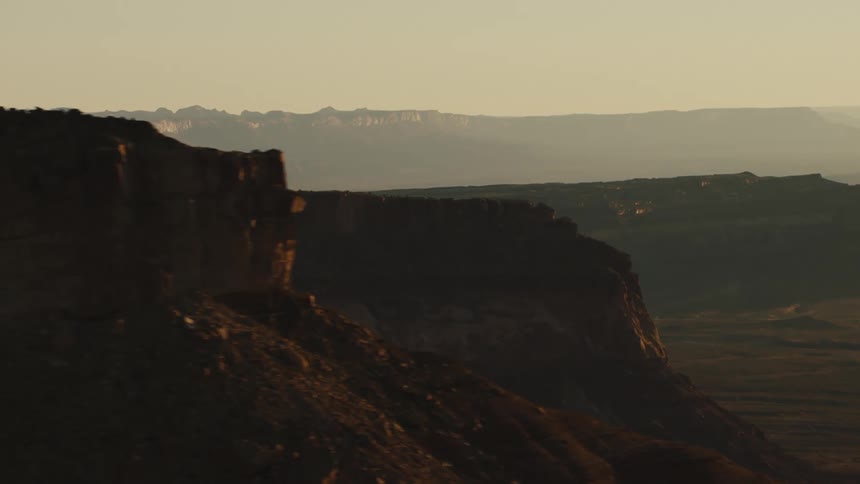 The cliff is steep above the desert