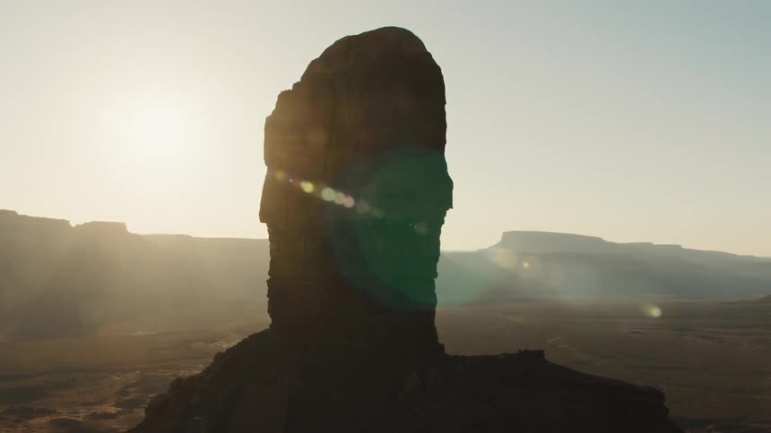 The sun rises over a canyon