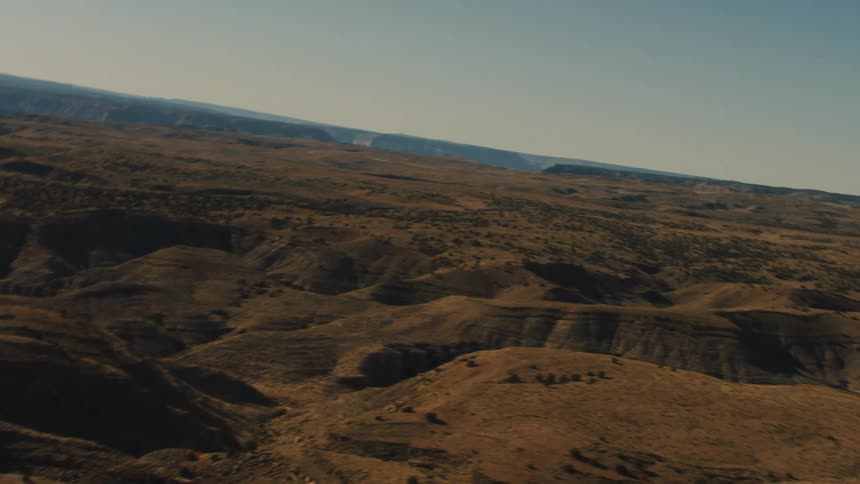 Canyons cut through a flat barren area