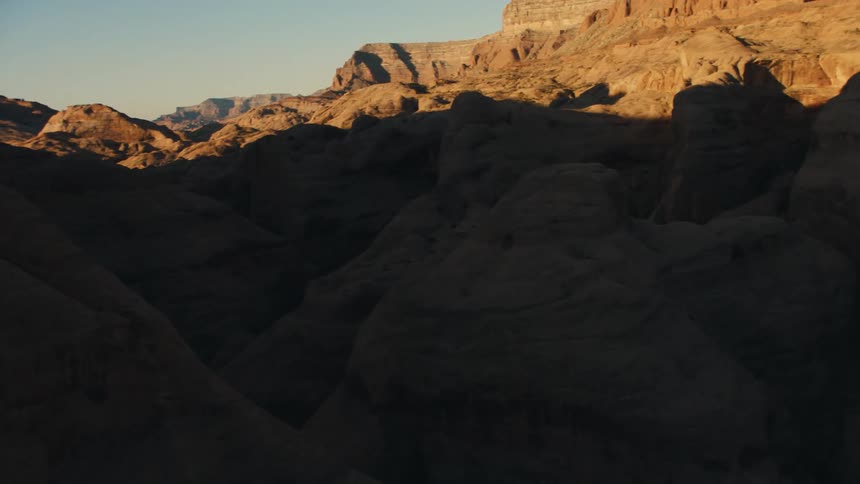 A rocky area with peaks and valleys is illuminated by the sun