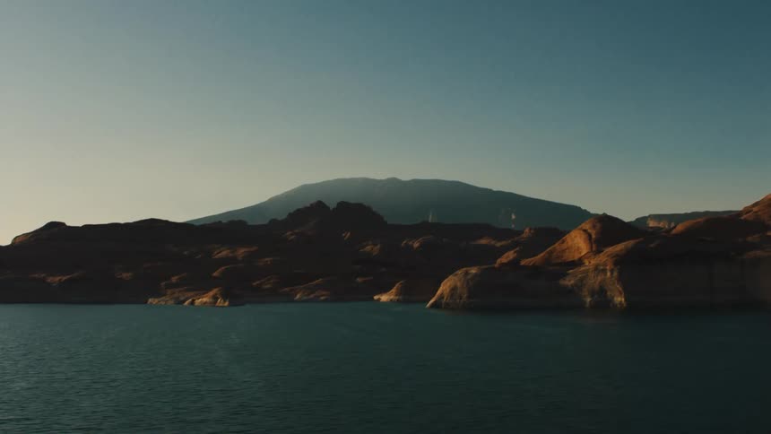 Mountain summit rises above cliffs on ocean shore
