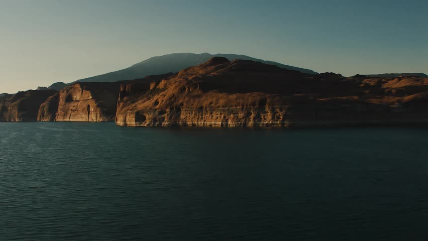 Aerial view of the water and cliffs along a shoreline