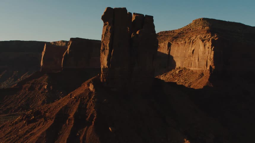 The canyon is covered in shadows from the cliffs