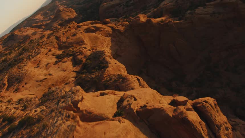 Aerial view of cliffs in the mountains on the badlands desert at sunset