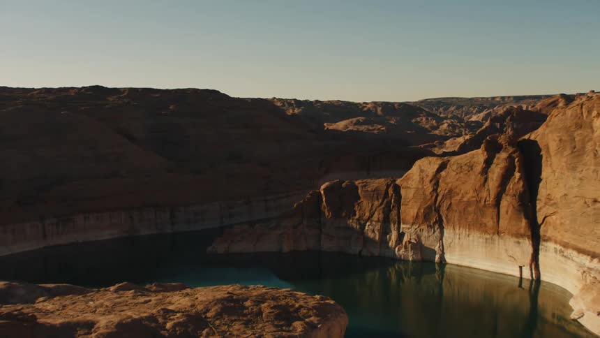 An aerial view of a mountain at dusk is displayed