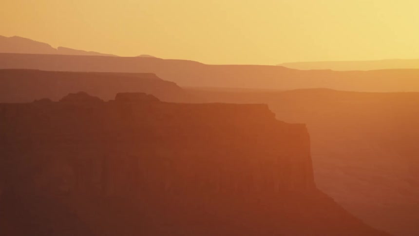 The sunlight over a landscape with canyons