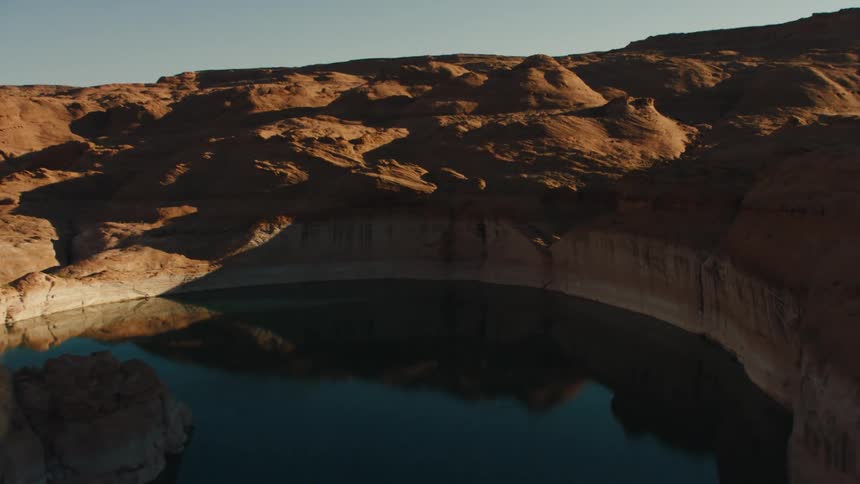 River winding through badlands reflects sky
