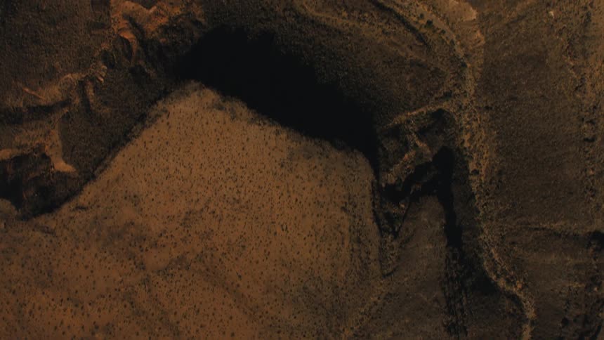 A desert with sand canyons and cliffs