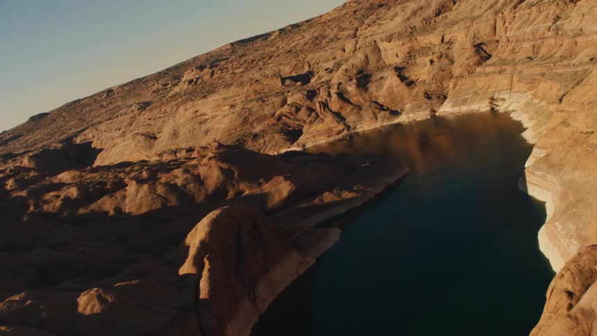 A lakefills the low areas between rocky slopes