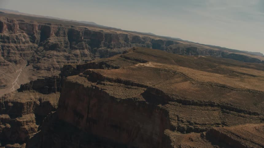 The cliffs of an enormous canyon on a sunny day