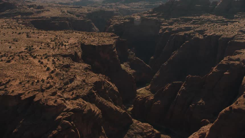 Aerial view of a canyon through a mesa in the desert