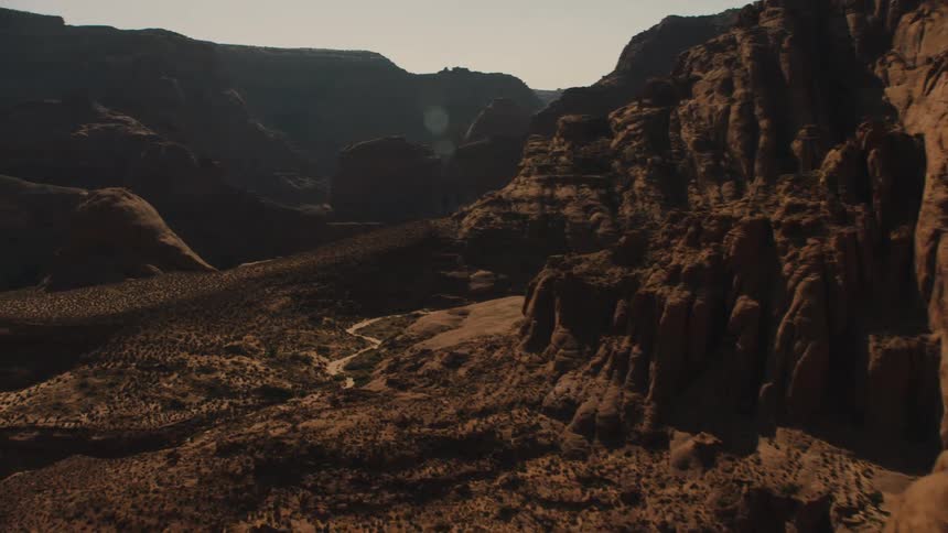 Scrub occupies valley between mountains in badlands
