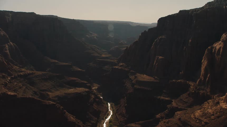 River flowing at the bottom of a canyon between mesas in the badlands