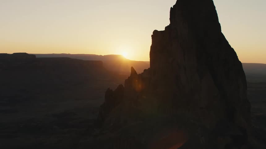 The sun setting over a rock formation