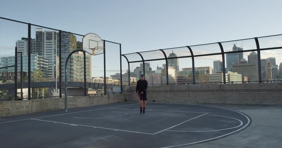 A man jumps rope on a basketball court