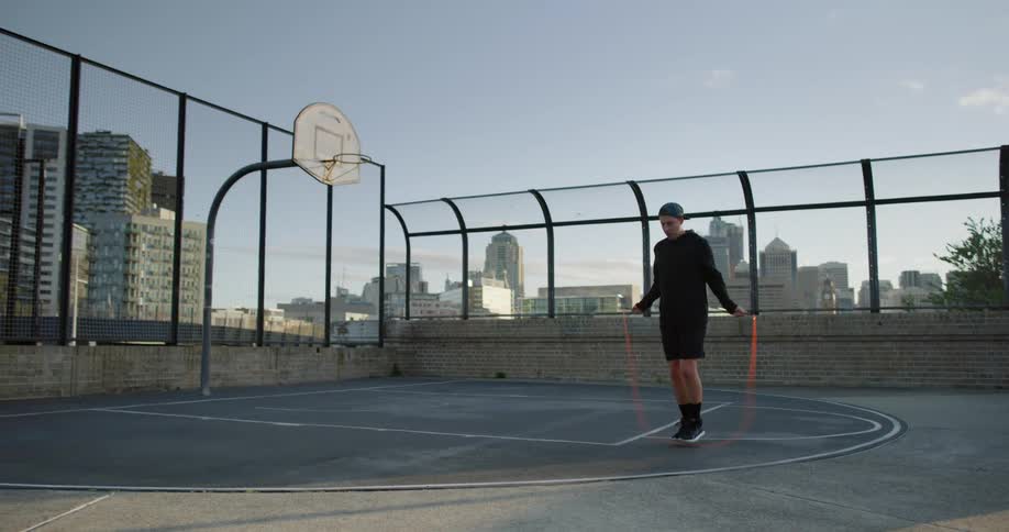A man jumps rope on a basketball court